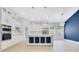 Modern kitchen featuring white cabinets, marble countertops, stainless appliances, and gold accents at 3507 W Jefferson St, Orlando, FL 32805