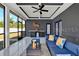 Spacious screened-in patio with modern furniture, ceiling fan, and outdoor bar area at 3507 W Jefferson St, Orlando, FL 32805