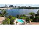 Aerial community view overlooking the lake, palm trees, and a community pool on a sunny day at 386 Lakeview St, Orlando, FL 32804