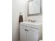 Updated half bathroom features a white vanity, chrome fixtures and decorative mirror at 386 Lakeview St, Orlando, FL 32804