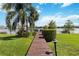 Waterfront dock with lounge chairs and beautiful view of the lake and palm trees on a sunny day at 386 Lakeview St, Orlando, FL 32804
