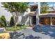 Home exterior with stucco, lush landscaping, mature tree, driveway, and two car garage at 386 Lakeview St, Orlando, FL 32804