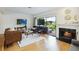Bright living room with a fireplace, wood floors, and sliding glass doors to a private patio at 386 Lakeview St, Orlando, FL 32804
