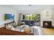 A sunlit living room featuring a cozy fireplace and seamless access to an outdoor space at 386 Lakeview St, Orlando, FL 32804