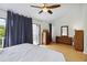 Light-filled main bedroom with sliding door to balcony, wood floors, and dresser at 386 Lakeview St, Orlando, FL 32804