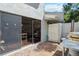 Outdoor patio with brick flooring, sliding glass doors, a wooden gate, and a built-in pizza oven at 386 Lakeview St, Orlando, FL 32804