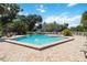 Community pool with brick pool deck, palm trees, lounge chairs, and beautiful trees at 386 Lakeview St, Orlando, FL 32804