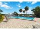 Community pool with brick pool deck, palm trees, lounge chairs, and lake view at 386 Lakeview St, Orlando, FL 32804