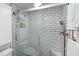 Close up of tiled shower with glass door, rain shower head, and built-in shelving at 386 Lakeview St, Orlando, FL 32804