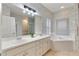 Spacious bathroom features dual sinks, a large mirror, and separate shower and tub at 4110 Maplegrove Dr, Orlando, FL 32818