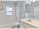 Bathroom featuring a tub and shower combo, decorative wallpaper, and a vanity sink at 4110 Maplegrove Dr, Orlando, FL 32818
