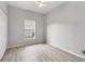 This simple bedroom features wood laminate flooring and a window at 4110 Maplegrove Dr, Orlando, FL 32818