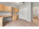 Bedroom with a built-in desk, shelving, a closet, and wood laminate flooring at 4110 Maplegrove Dr, Orlando, FL 32818