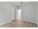 This bright bedroom features wood floors, fresh paint, and a double closet at 4110 Maplegrove Dr, Orlando, FL 32818