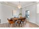 Modern dining room with wood table, stylish chairs, chandelier and bright natural light at 4110 Maplegrove Dr, Orlando, FL 32818