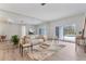 Bright living room featuring hardwood floors, stylish seating, and sliding glass doors to the pool area at 4110 Maplegrove Dr, Orlando, FL 32818
