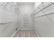Walk-in closet includes laminate flooring and metal shelving for optimal storage at 4110 Maplegrove Dr, Orlando, FL 32818