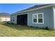 Exterior view of the home featuring blue siding and trim, plus a screened-in porch at 4167 Clifden Dr, Ormond Beach, FL 32174