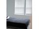 Simple bedroom with a dark bedspread and natural light streaming through the window at 4167 Clifden Dr, Ormond Beach, FL 32174