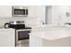 Kitchen with stainless steel appliances and white cabinets at 4167 Clifden Dr, Ormond Beach, FL 32174