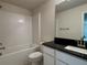 Modern bathroom with subway tile shower, black granite vanity, and sleek fixtures at 4170 Sagefield Dr, Harmony, FL 34773