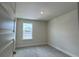 A neutral-toned bedroom features plush carpeting and a window with a clear view of the outdoors at 4170 Sagefield Dr, Harmony, FL 34773