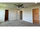 A carpeted bedroom featuring a ceiling fan and access to both a closet and a bathroom at 4170 Sagefield Dr, Harmony, FL 34773