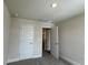 Carpeted bedroom with neutral walls, showing closet space and an open door at 4170 Sagefield Dr, Harmony, FL 34773