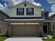 Charming two-story home showcasing a two-car garage and a well-maintained front yard at 4170 Sagefield Dr, Harmony, FL 34773