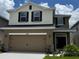 Charming two-story home with a large garage, attractive facade, and well-maintained landscaping at 4170 Sagefield Dr, Harmony, FL 34773