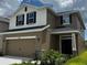 Beautiful two-story home with a two-car garage, complemented by manicured landscaping at 4170 Sagefield Dr, Harmony, FL 34773