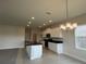 Eat-in kitchen with center island, pendant lighting, and stainless steel appliances at 4170 Sagefield Dr, Harmony, FL 34773