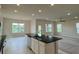 Open kitchen with black countertops, stainless steel appliances, and views of the backyard pond at 4170 Sagefield Dr, Harmony, FL 34773