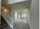 Bright, carpeted living room with staircase, large windows, and an open floor plan at 4170 Sagefield Dr, Harmony, FL 34773