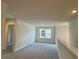 Upstairs loft area with neutral tones and natural light from a window at 4170 Sagefield Dr, Harmony, FL 34773