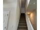 Carpeted staircase with white railings leading to the upper level at 4170 Sagefield Dr, Harmony, FL 34773