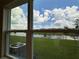 Window view of a pond and green space at 4170 Sagefield Dr, Harmony, FL 34773