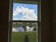 Window view of a tranquil pond surrounded by lush greenery at 4170 Sagefield Dr, Harmony, FL 34773