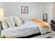 Bright bedroom features a comfortable bed with plush pillows and a mirror in the corner at 4654 Alhama St, Orlando, FL 32811