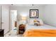 Cozy bedroom featuring patterned tile floors, a comfortable bed, and an ensuite bathroom at 4654 Alhama St, Orlando, FL 32811