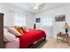 Bright bedroom with ceiling fan, two windows with curtains, comfortable bed, and stylish decor at 4654 Alhama St, Orlando, FL 32811