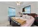 Cozy bedroom features a bed, ceiling fan, and two windows with blue curtains at 4654 Alhama St, Orlando, FL 32811