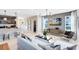 Open-concept living room featuring modern lighting, neutral tones, and stylish furnishings adjacent to the kitchen at 5015 Starling Bird Ln, St Cloud, FL 34771
