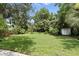 Expansive backyard showcasing a well-manicured lawn, a shed, and mature trees at 509 Altaloma Ave, Orlando, FL 32803