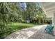 Secluded backyard offering a patio, mature trees, and a spacious green lawn at 509 Altaloma Ave, Orlando, FL 32803