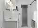 Well-lit white bathroom with glass door shower, vanity and towel rack at 509 Altaloma Ave, Orlando, FL 32803