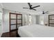 Primary bedroom featuring modern closets, two ceiling fans, multiple access doors and dark wood flooring at 509 Altaloma Ave, Orlando, FL 32803