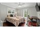 Cozy bedroom with a ceiling fan, dark wood floors, and a door to the outside at 509 Altaloma Ave, Orlando, FL 32803