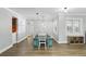 Bright dining room featuring a light fixture, a dining table with bench, plantation shutters and hardwood floors at 509 Altaloma Ave, Orlando, FL 32803