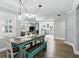 Bright dining area leads to the living room and kitchen; includes pendant lighting and a turquoise picnic-style dining set at 509 Altaloma Ave, Orlando, FL 32803
